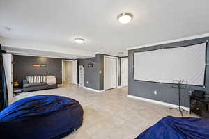 Bedroom featuring a textured ceiling and baseboards
