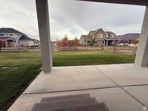 Fenced backyard with a patio area and a residential view