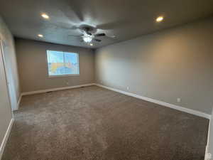 Carpeted empty room with recessed lighting, ceiling fan, and a textured ceiling