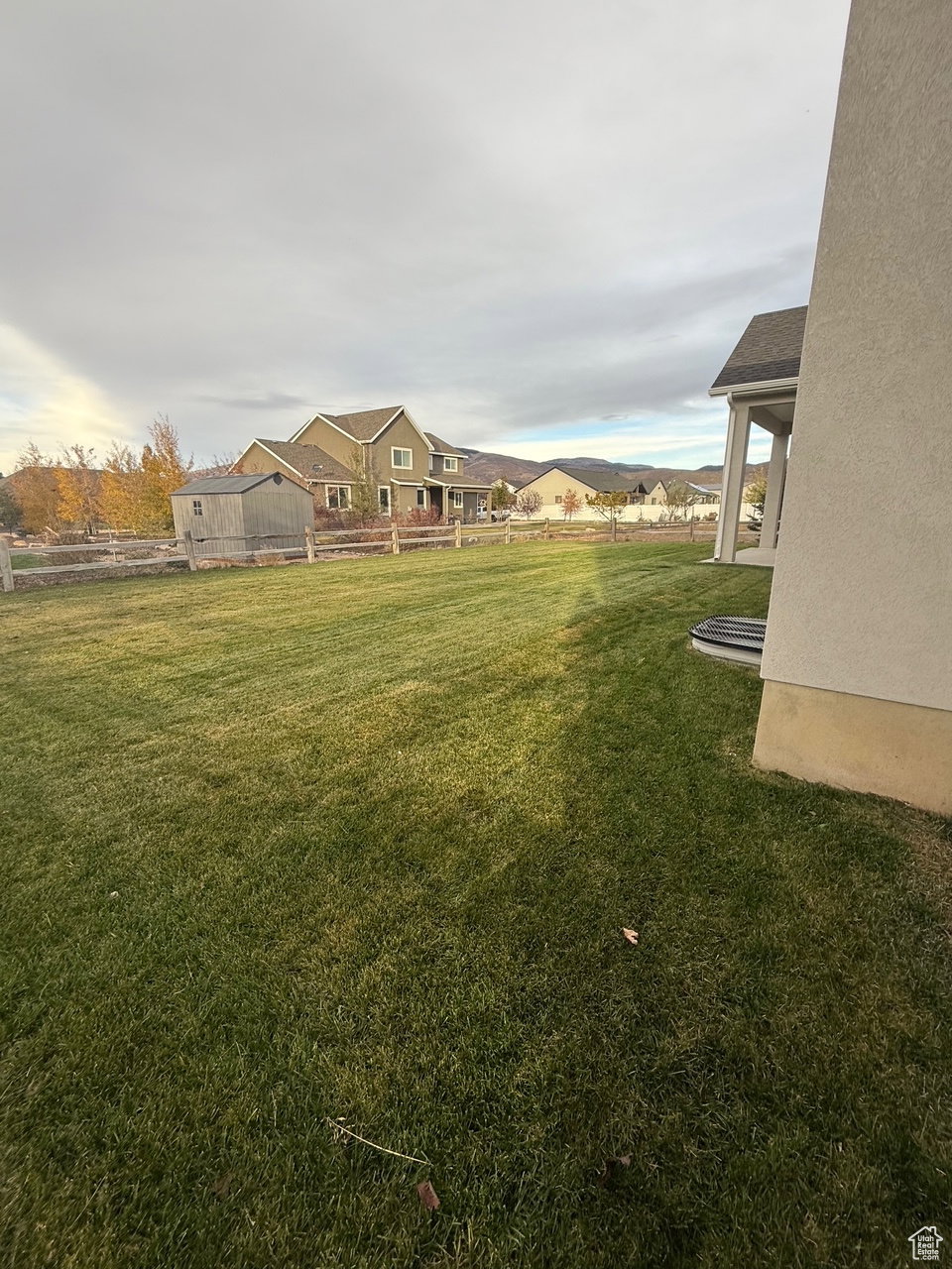 View of green lawn with a patio