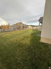 View of green lawn with a patio