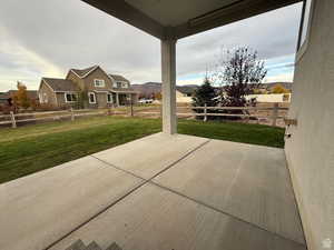 Fenced backyard featuring a patio and a residential view
