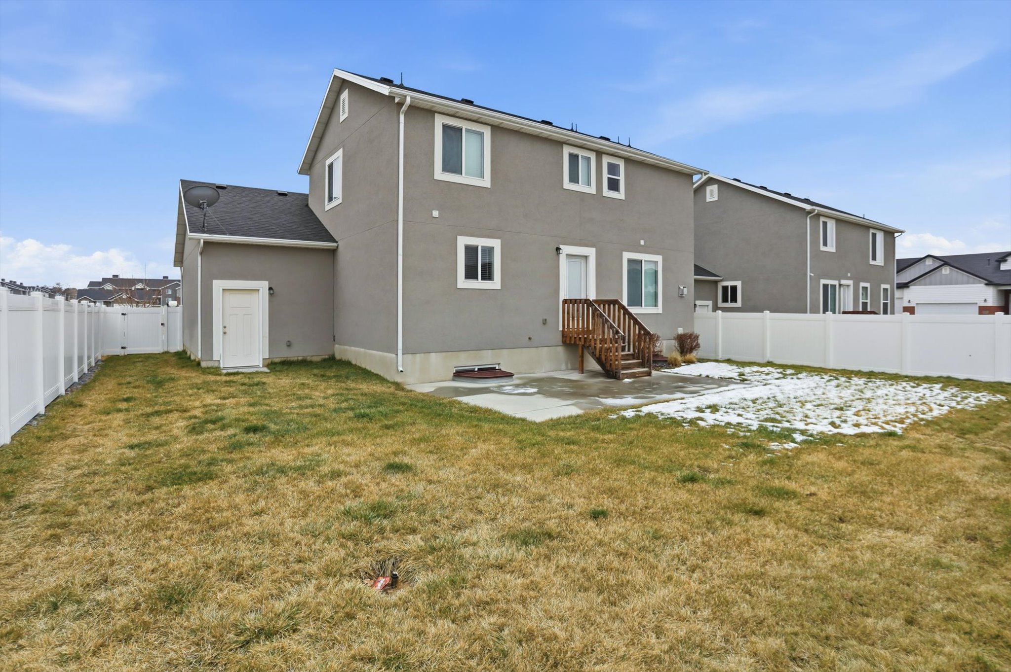 Rear view of property with a patio, a fenced backyard, and stucco siding