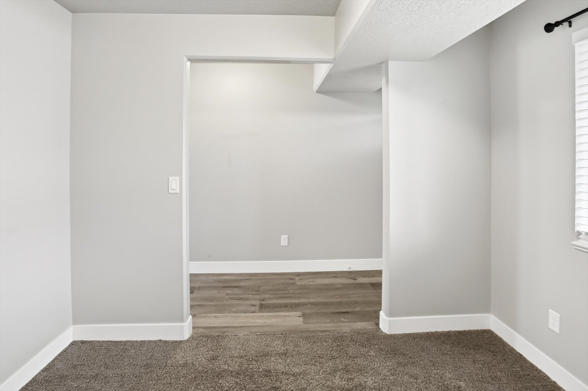 Spare room featuring carpet floors and a textured ceiling