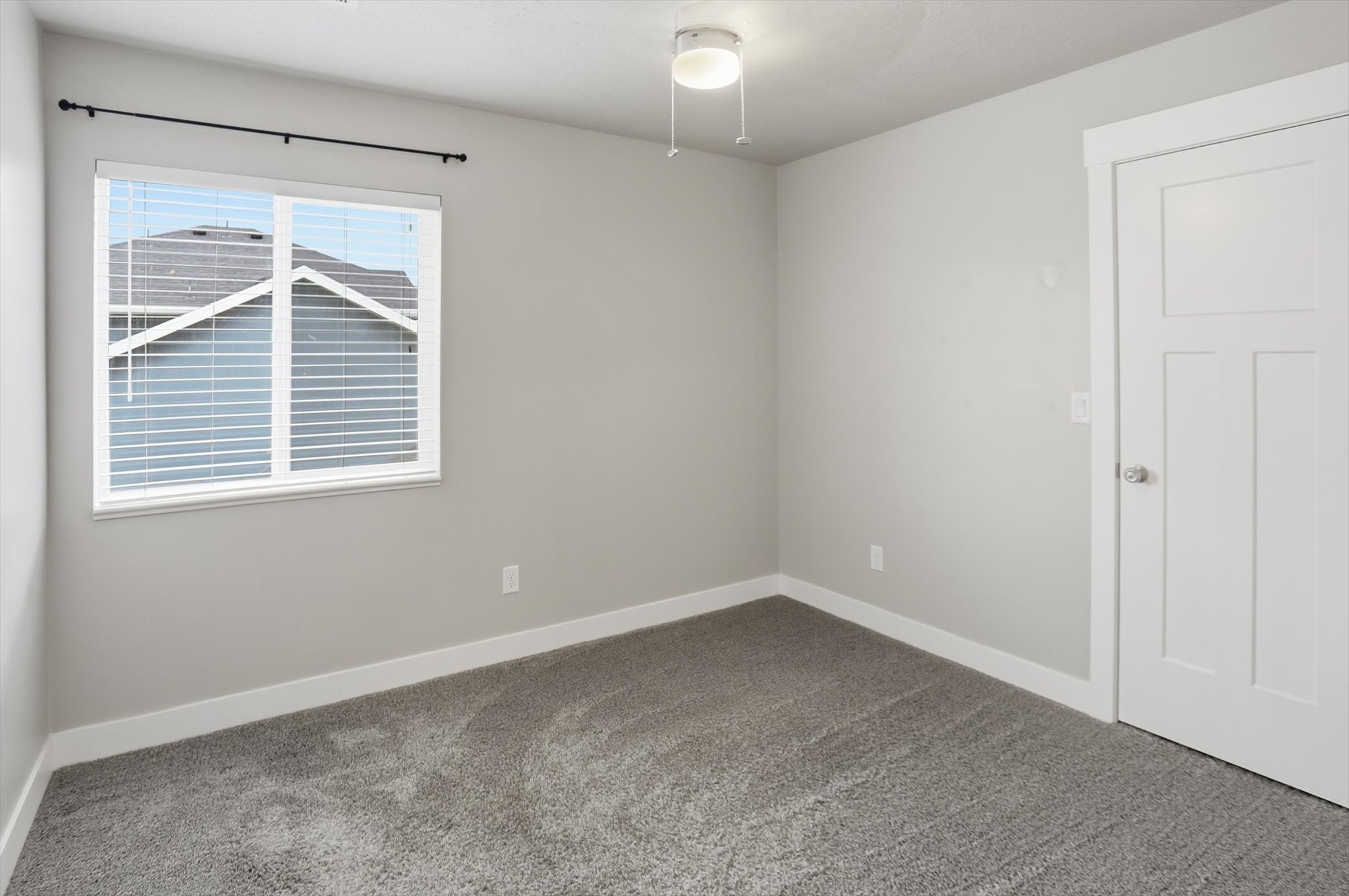 Carpeted empty room featuring baseboards