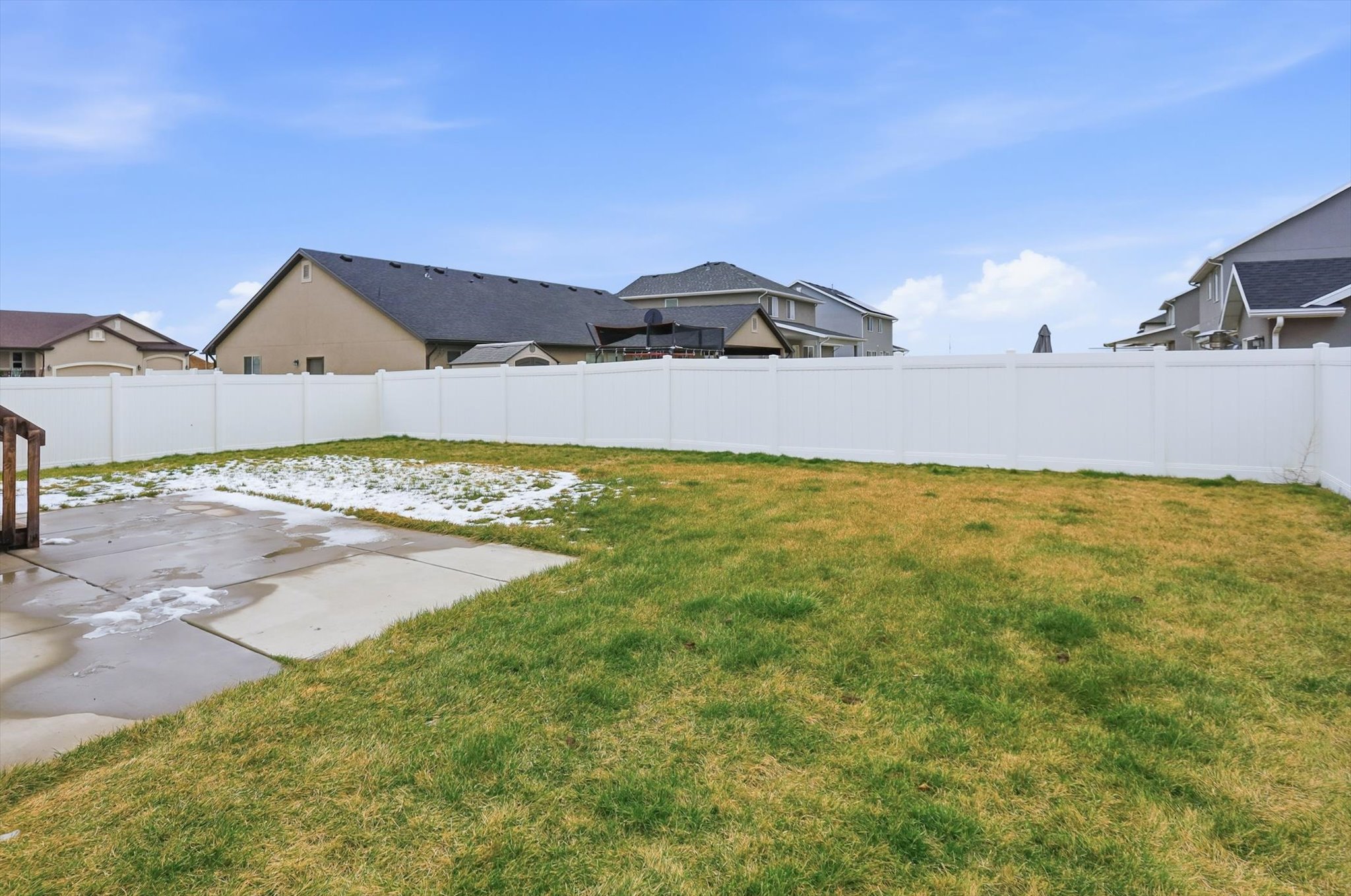 Fenced backyard with a patio area and a residential view