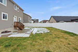 Fenced backyard featuring a residential view and a patio