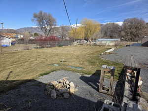 View of yard with a mountain view and a fire pit
