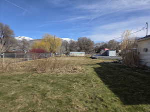 View of yard with a mountain view and an outdoor structure