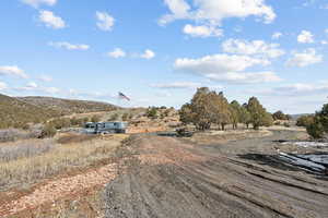 View of dirt / gravel road with a view of countryside and a mountain view