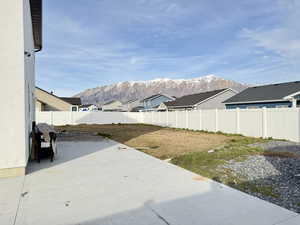 Fenced backyard with a patio area and a mountain view