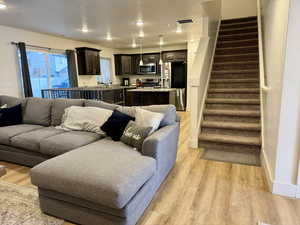 Living area with a textured ceiling and light wood finished floors