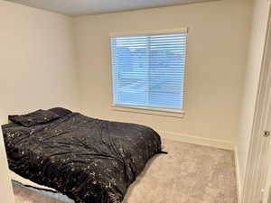 Carpeted bedroom with baseboards