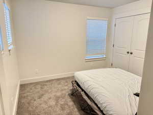 Bedroom with carpet and a closet