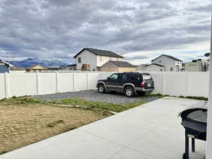 Fenced backyard featuring a mountain view and a residential view