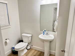 Bathroom featuring toilet and light wood-style floors
