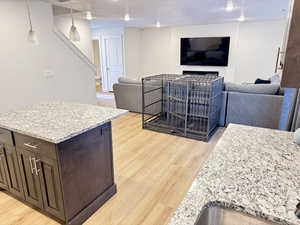 Living room featuring light wood finished floors and a textured ceiling