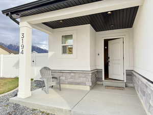 Property entrance with a mountain view and stone siding