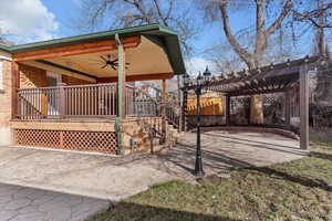 View of side of home with ceiling fan and a patio