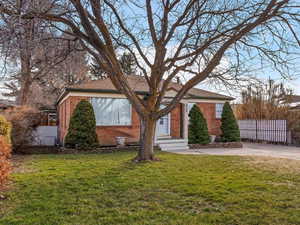 View of front of home featuring brick siding and driveway