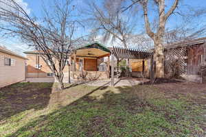 Rear view of house featuring ceiling fan, a fenced backyard, a patio, and a pergola