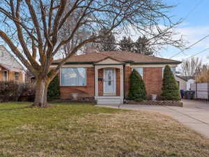 Single story home with brick siding and concrete driveway