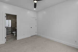 Unfurnished bedroom with light carpet, connected bathroom, a ceiling fan, and recessed lighting