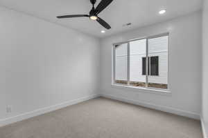Spare room featuring light carpet, a ceiling fan, and recessed lighting