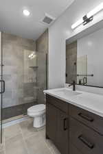 Bathroom with vanity, a stall shower, light tile patterned floors, and recessed lighting