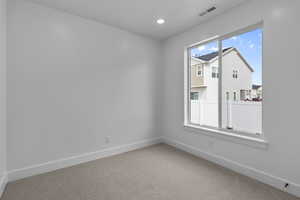 Unfurnished room featuring carpet and recessed lighting