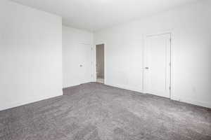 Unfurnished bedroom featuring baseboards and carpet floors