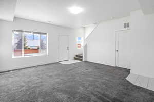 Empty room with carpet flooring and plenty of natural light