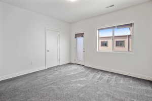 Unfurnished room featuring light carpet and baseboards