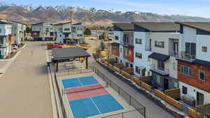 Balcony featuring a tennis court, a mountain view, a residential view, and a grill