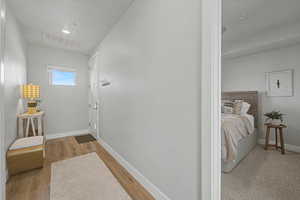 Corridor with baseboards and light wood-style floors