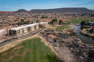 Bird's eye view of a golf course and a water and mountain view