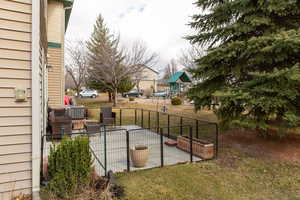 View of grassy yard featuring a patio and a playground