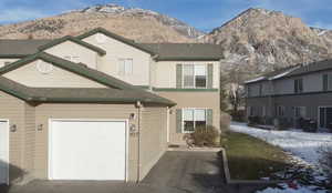 Traditional-style home featuring a mountain view and driveway