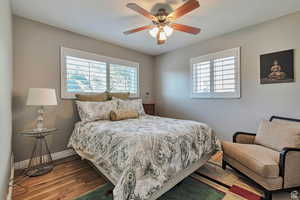 Bedroom with wood finished floors and ceiling fan