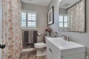Full bathroom featuring vanity and curtained shower