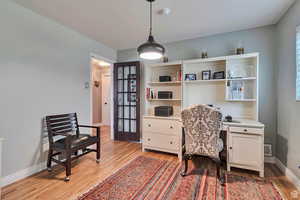 Home office with baseboards and light wood-style floors