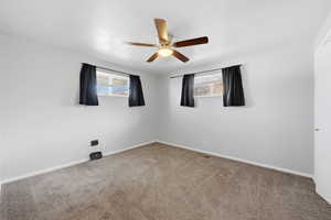 Empty room with carpet and a ceiling fan