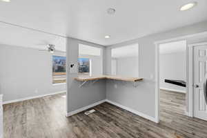 Walk in closet with dark wood finished floors