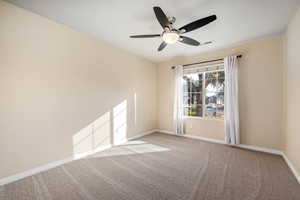 Bedroom featuring a ceiling fan and light with fresh paint and new carpet