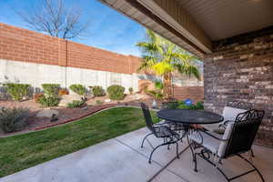 Fenced backyard with outdoor dining space and a patio