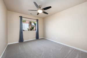 Spare room with light colored carpet and ceiling fan