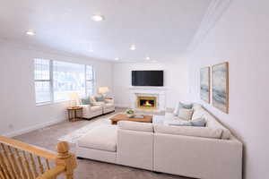 Living room featuring ornamental molding, carpet flooring, a high end fireplace, and recessed lighting. AI Decor.