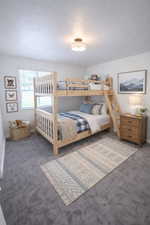 Bedroom featuring carpet floors and a textured ceiling