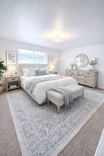 Primary Bedroom featuring carpet floors and a textured ceiling