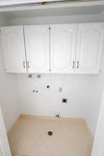 Laundry room with gas dryer hookup, washer hookup, cabinet space, and electric dryer hookup
